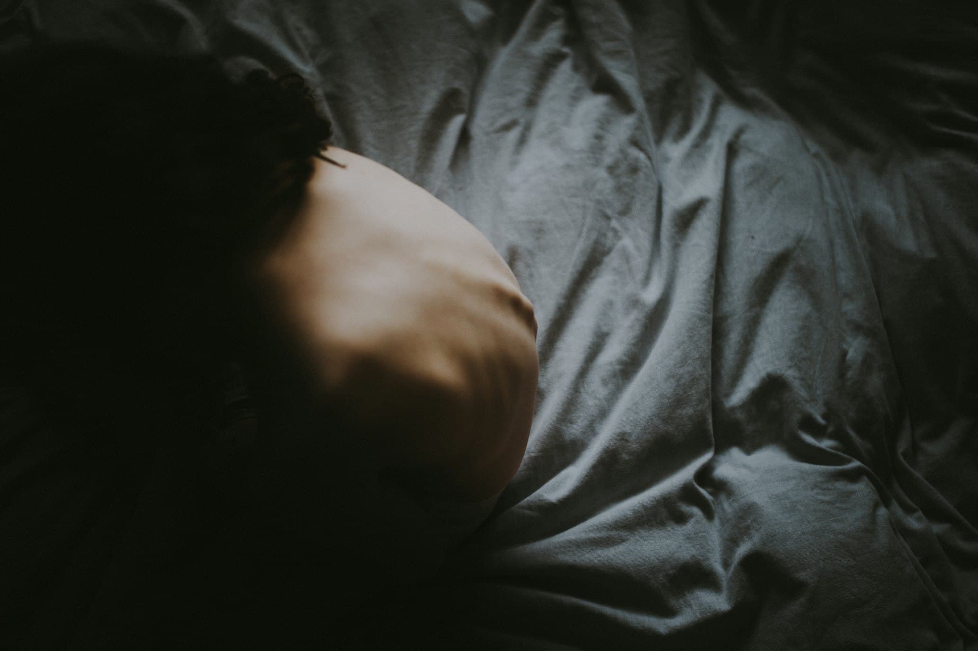 An athlete asleep in a dark room