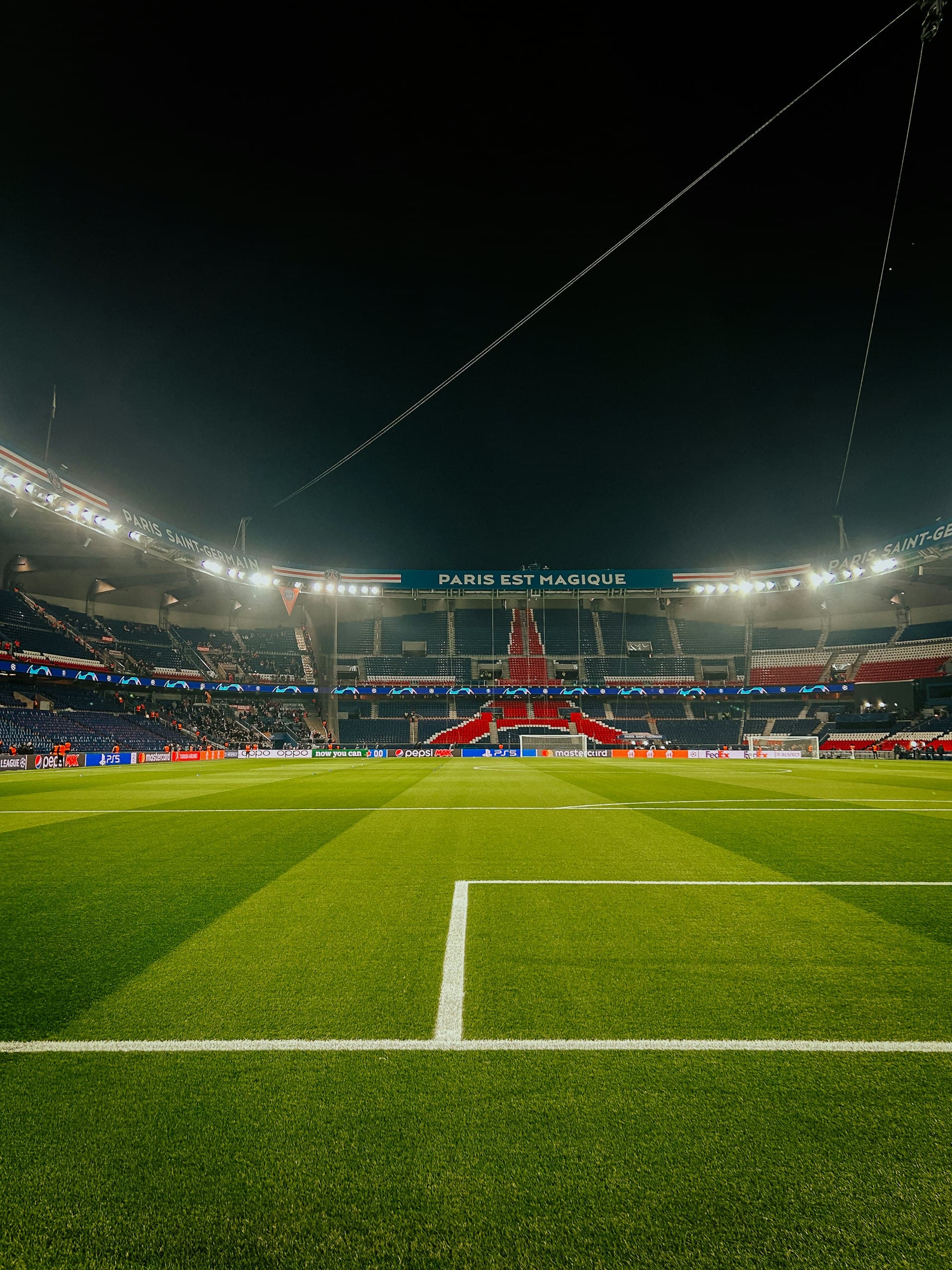 A stadium pitch under floodlights at night